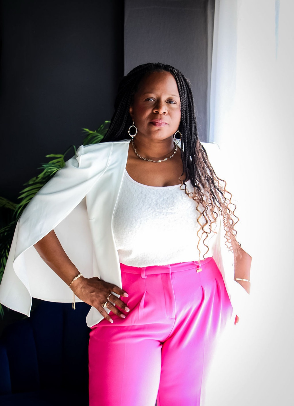 Selena D. Jackson in a white jacket and pink trousers